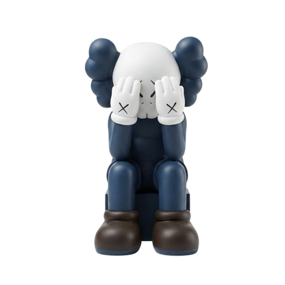 A stylized seated figurine resembling a character with a white head, dark blue body, dark blue hair-like shapes, white gloves with black X marks, and dark brown boots, centered on a plain white background.