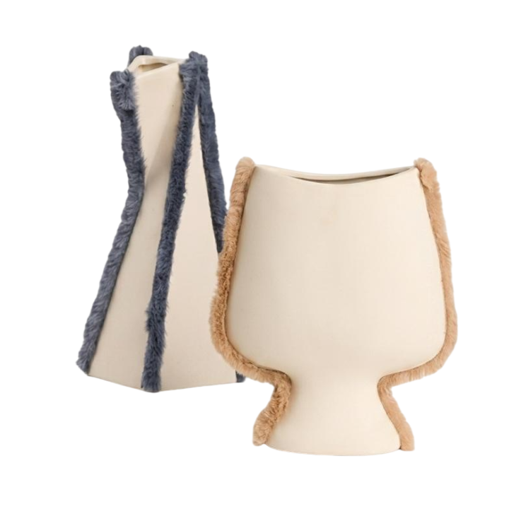 Two modern ceramic vases on a plain white background. One vase is cream-colored with dark blue frayed trim, and the other is cream-colored with light brown frayed trim.