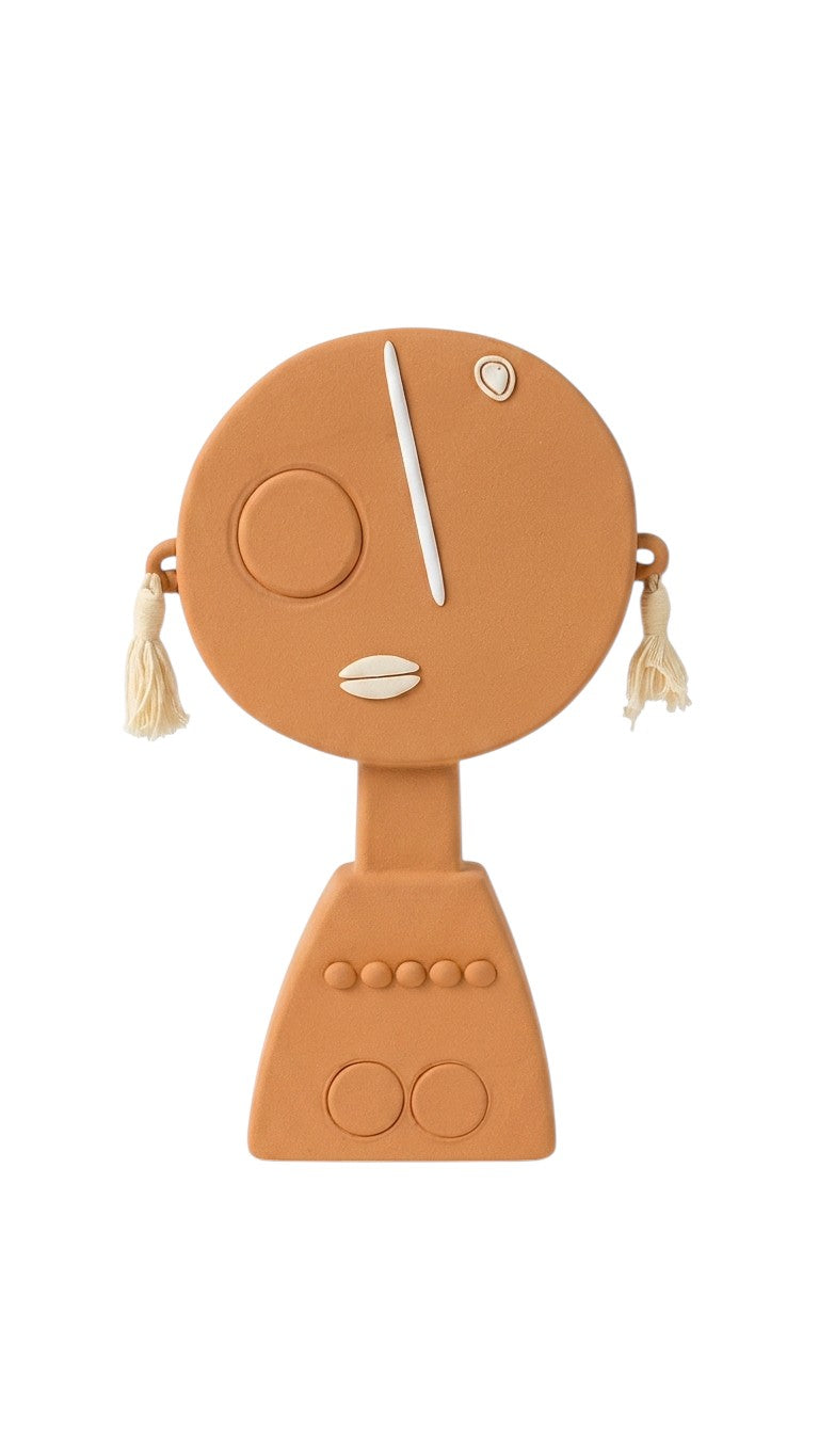 Ciel Casa terracotta artisan display figurine with white accents and cream tassels. Features a circular head with a single eye and mouth.