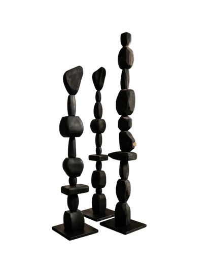 Three black stone sculptures on a white background
