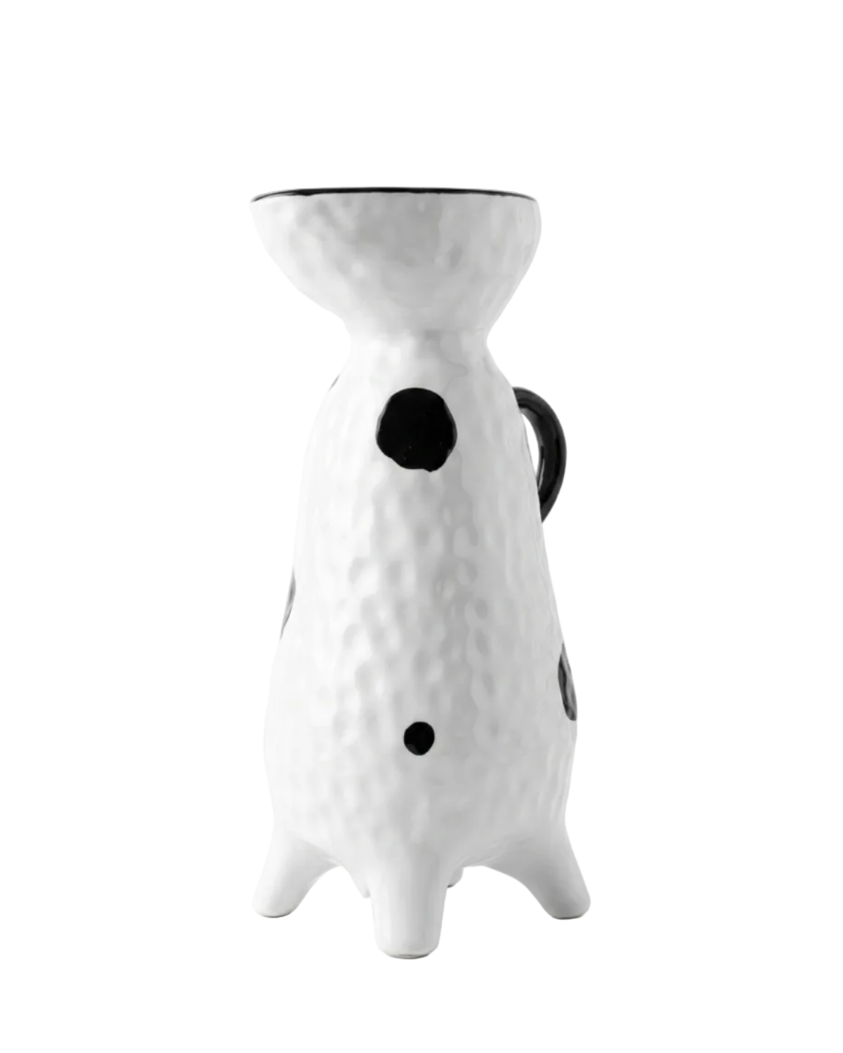 White ceramic pitcher with black dots on a white background