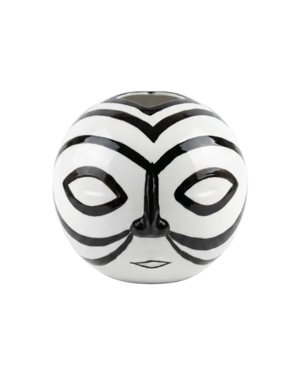 Black and white striped ball with a face design on a white background