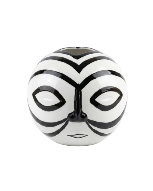 Black and white striped ball with a face design on a white background