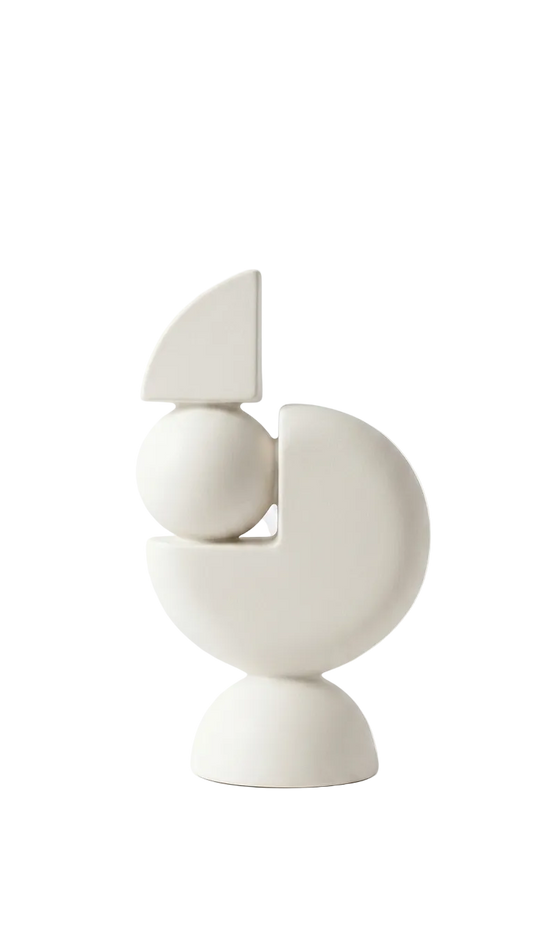 White ceramic sculpture with geometric design on a white background