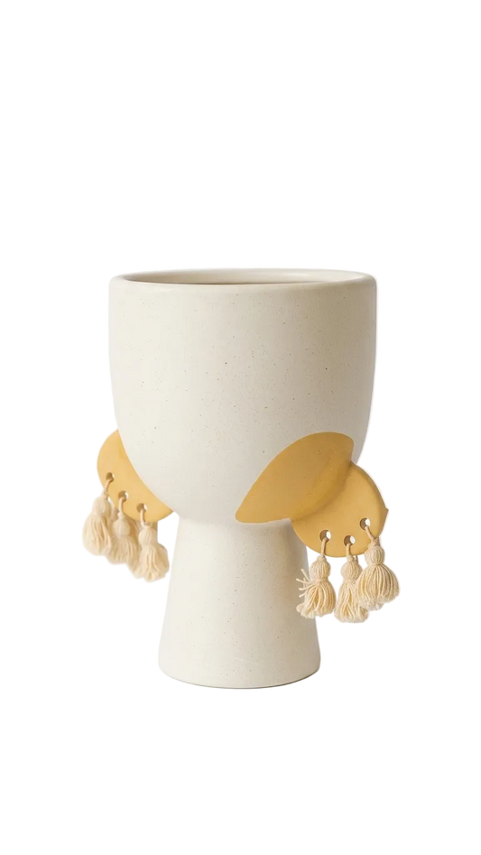 White ceramic vase with gold leaf-like decorations on a white background
