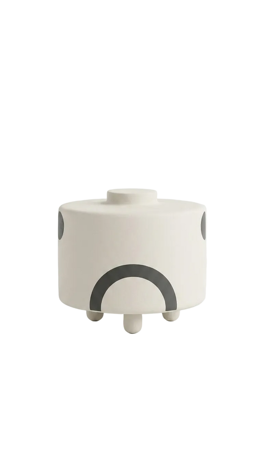 White planter with black geometric designs on a white background